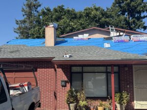 In progress composition shingle roof replacement on a tree-lined Menlo Park, CA street by Home Pro Roofing and Solar